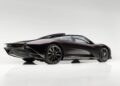 A sleek, black ultra-low mile McLaren Speedtail with $250k in MSO options is shown in a studio setting, photographed from the rear side against a plain white background.