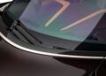 Close-up of a car windshield showing windshield wipers, carbon fiber trim, and reflections on the glass—capturing the meticulous detail found in an ultra-low mile McLaren Speedtail with $250k in MSO options heading to auction.