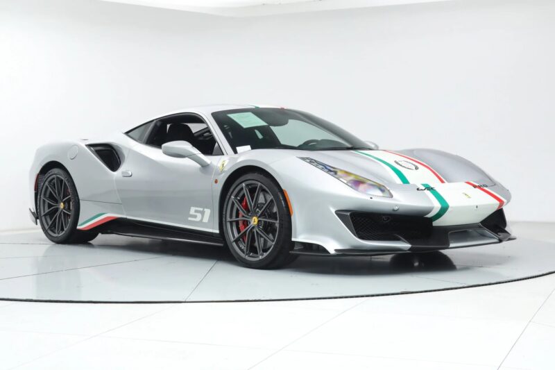 Track-ready Ferrari 488 Pista sports car with green, white, and red racing stripes, number 51 on the door, and black wheels, displayed in a white studio setting.