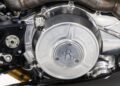 Close-up of a metallic Brough Superior motorcycle engine, showcasing the engraved brand name and mechanical components, similar to the craftsmanship found in the Aston Martin AMB 001 offered by Sotheby's Motorsport in 2022.