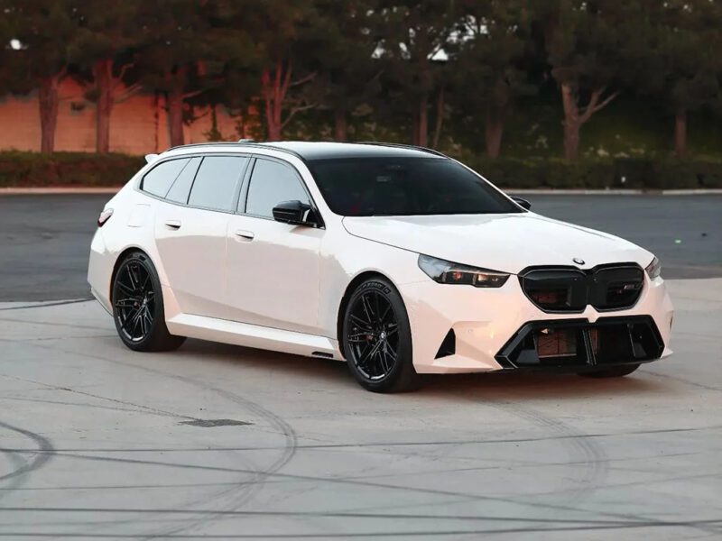 A white car parked on a concrete surface, capturing the refined style and versatility often found in luxury wagons.