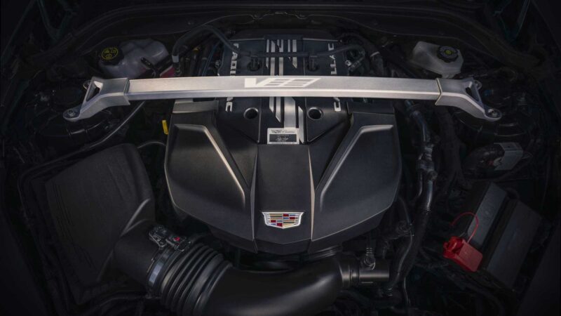 Close-up view of a Cadillac V-series engine bay, showcasing the engine cover, V logo strut brace, and components—highlighting The Last V8-Powered Sedan To Offer A Manual In 2025.