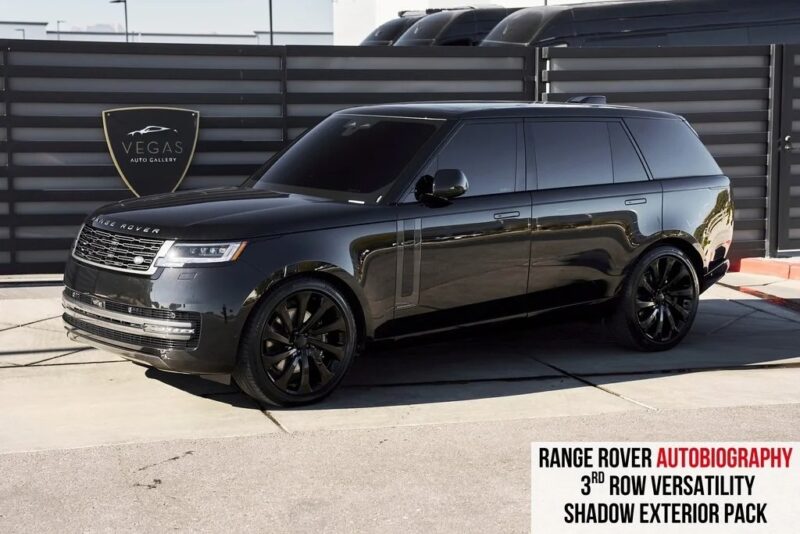 A black Range Rover SUV with tinted windows is parked outdoors near a sign reading "Vegas Auto Gallery." Text highlights its Autobiography trim, 3rd row versatility, Shadow Exterior Pack, and status among the best luxury SUVs.