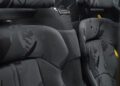 Close-up of two black Ferrari Tailor Made Daytona SP3 car seats with camouflage-patterned upholstery, yellow Ferrari logos on the headrests, and visible carbon fiber detailing.