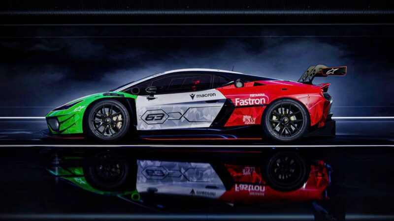 Side view of a Lamborghini race car with sponsor logos, featuring a green, white, and red color scheme under dramatic lighting—Temerario GT3 marks Lamborghini’s next chapter in GT3 endurance racing.