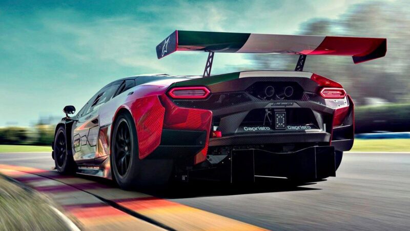 A rear view of the Temerario GT3 marks Lamborghini’s next chapter in GT3 endurance racing, its large rear wing slicing through the air as it speeds around the racetrack, with a blurred background underscoring its impressive velocity.