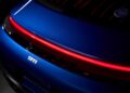 Close-up of the rear end of a blue Limited-Run 2026 911 Carrera T Club Coupe with a red LED tail light, "911" badge, and part of the rear deck badge—celebrating 70 years of Porsche Club of America.