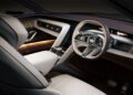 Luxury Bentley EV Concept interior featuring light-colored seats, a minimalist dashboard, digital displays, ambient lighting, and the iconic Bentley logo on the steering wheel.