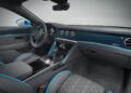 Luxury Bentley car interior featuring blue and gray leather seats, detailed stitching, a digital display, round air vents, and carbon fiber dashboard trim—showcasing exceptional Mulliner interior options.