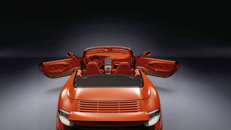 A red Porsche convertible sports car shown from the rear with both doors open, revealing its interior against a dark gradient background—a striking example of exclusive customer requests and factory one-off cars.