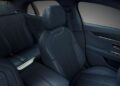 The image shows the interior of a Bentley luxury car featuring dark quilted leather seats, detailed stitching, and a modern door panel with metallic accents—showcasing refined Mulliner Interior options.