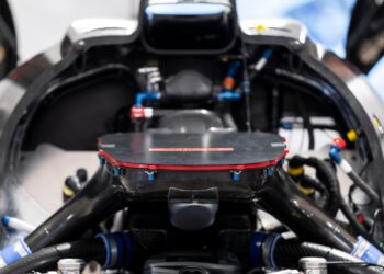 Close-up view of the GMR‑001 Hypercar’s V8 Twin-Turbo engine, showcasing carbon fiber components, wiring, and hoses—embodying Genesis Magma Racing performance.