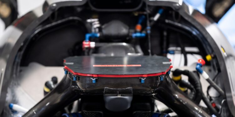 Close-up view of the GMR‑001 Hypercar’s V8 Twin-Turbo engine, showcasing carbon fiber components, wiring, and hoses—embodying Genesis Magma Racing performance.