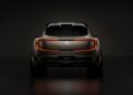 Rear view of the Bentley EXP 15 electric vehicle concept, featuring a continuous red LED tail light and the Bentley logo, set against a dark background.
