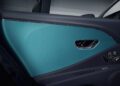 Close-up view of a Bentley’s Mulliner Interior door panel featuring teal and black colors, chrome trim, and electronic seat adjustment controls, highlighting the new options available.