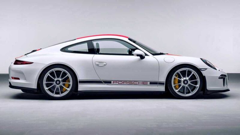 A 2016 Porsche 911 R sports car with black and red detailing is shown in a side profile view against a plain background.
