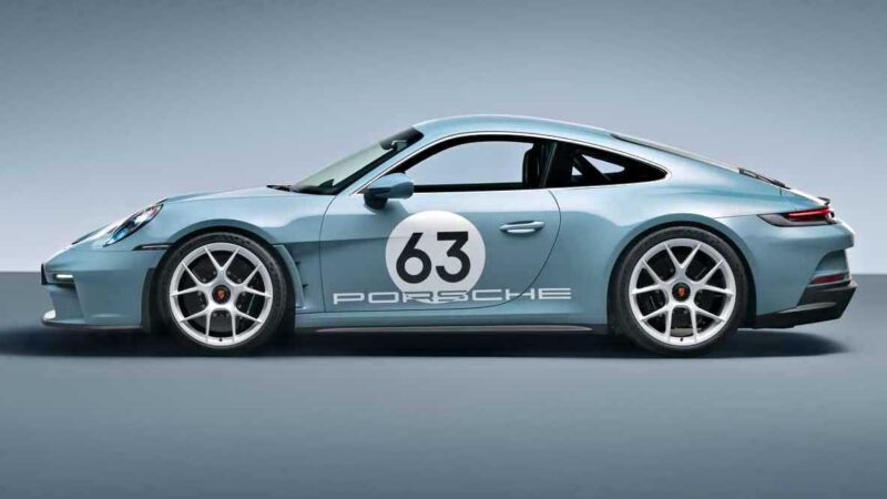 A light blue 2016 Porsche 911 R sports car with the number 63 and "Porsche" decal on the side, shown in a studio setting with a plain background.