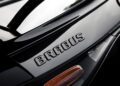 Close-up of the rear section of a black AMG GT showcasing the "BRABUS" emblem above a tail light on this stunning Hybrid Supercar.