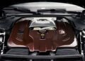 Close-up view of a BRABUS 1000 engine with red carbon fiber cover inside an AMG GT’s engine bay.