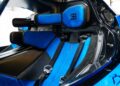 Interior of a luxury sports car with blue and black leather seats, harness seatbelts, and Bugatti logo on the headrests—the #001 of 40 Track-Only Bugatti Bolide set for auction debut at Pebble Beach.