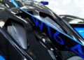 Close-up of a black and blue sports car engine cover with "W16" lettering, carbon fiber components, and aerodynamic details on the #001 of 40 Track-Only Bugatti Bolide set for auction debut at Pebble Beach.
