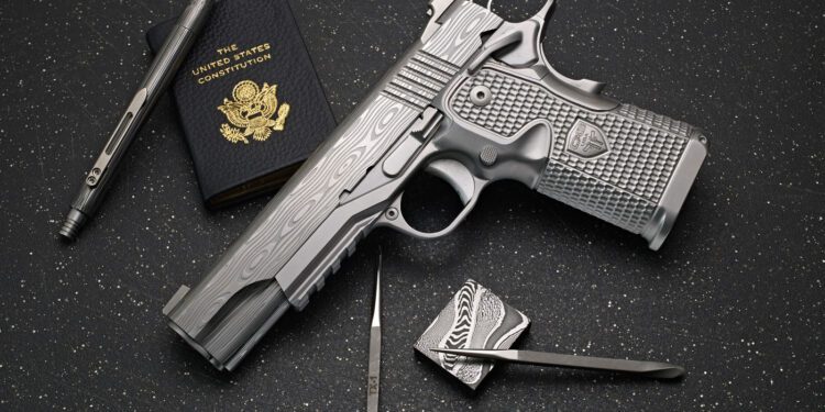 A silver-patterned Cabot Guns pistol, a U.S. passport, a pen, a metal lighter, and a metal tool arranged on a black speckled surface evoke an aura of legacy and precision.
