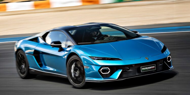 A blue V12 Revuelto Lamborghini is driving on a racetrack with a blurred background, indicating motion.