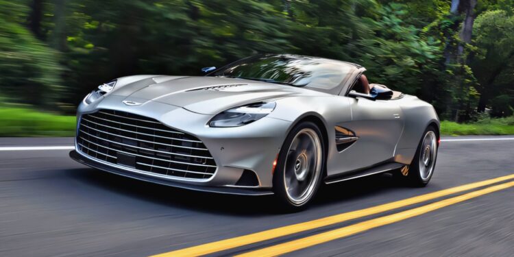 A 2026 Aston Martin Vanquish with a powerful V12 engine speeds along a two-lane road, flanked by green trees and blurred foliage, capturing the thrill of motion.