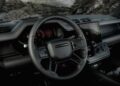 The interior of the 2026 Land Rover Defender OCTA Black features a modern dashboard, touchscreen display, digital instrument cluster, and multifunction steering wheel.