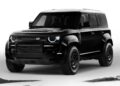 A 2026 Land Rover Defender in OCTA Black is parked on a white background, with patches of gravel and rocks visible beneath the SUV.