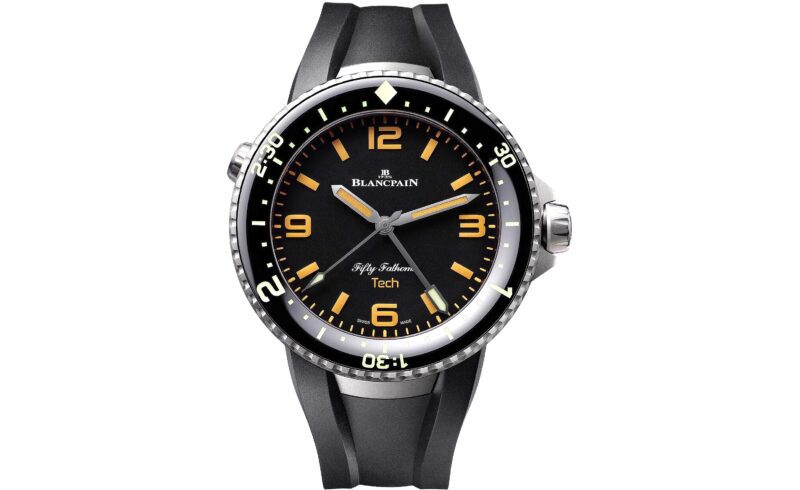 A Blancpain Fifty Fathoms Tech wristwatch, celebrated among the best luxury watches, features a black dial with yellow numerals and a black rubber strap, elegantly displayed against a white background.