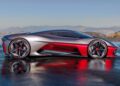 A sleek, silver and red futuristic sports car—reminiscent of the California Corvette: GM's Pasadena Studio Showcases One-Off Hypercar Concept—is parked outdoors on wet pavement, with distant mountains rising under a clear sky.