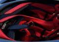 Top-down view of a futuristic car interior with red and black seats, a central console, and a high-tech steering wheel—reminiscent of the California Corvette: GM's Pasadena Studio Showcases One-Off Hypercar Concept.