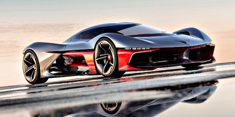 A sleek, futuristic red and black sports car with aerodynamic design is parked on a reflective surface under a clear sky—reminiscent of the California Corvette: GM's Pasadena Studio showcases this stunning one-off hypercar concept.