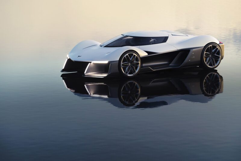 A futuristic white sports car with angular Corvette design and large wheels is parked on a reflective, water-like surface under soft lighting, blending classic American icon styling with modern innovation.