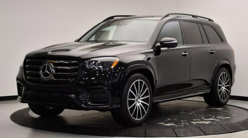 Black Mercedes-Benz SUV parked indoors on a circular display platform with a white background, perfect for those seeking the best lease deals or exploring attractive new car lease options.