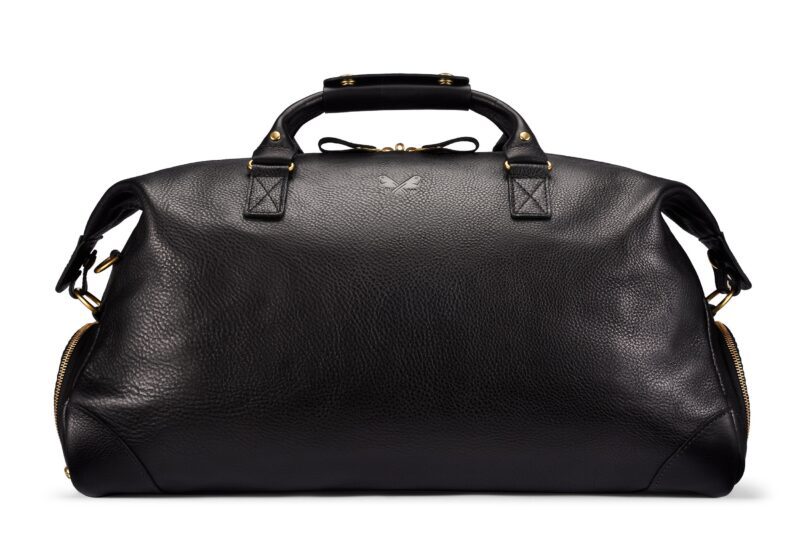A black leather duffel bag with short handles, gold-tone hardware, and zippered side pockets—an ideal style upgrade for anyone seeking luxury accessories, displayed elegantly on a white background.