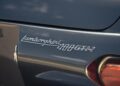 Close-up of the rear badge on a gray Lamborghini 400 GT 2+2, showcasing the car's model name in chrome—a timeless detail from vintage Lamborghinis born in Emilia-Romagna.