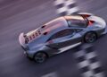 The Only Street-Legal Lamborghini Sesto Elemento wows Goodwood as this silver sports car, featuring a rear spoiler and hexagonal vent holes on the engine cover, drives at high speed on the road.
