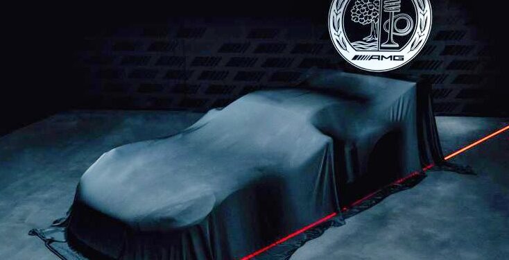 A car covered with a dark cloth sits beneath an illuminated AMG Affalterbach logo, hinting at the V8 Power and a Giant Wing: Mercedes Concept AMG GT Track Sport breaks cover, its form partially outlined by red lighting on a dark stage.