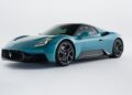 A blue 2026 Maserati MCPURA with an innovative liquid crystal roof and F1 tech is parked in a studio setting with a white background.