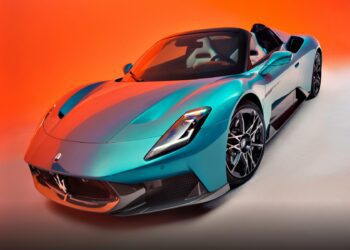 Turquoise Maserati MC20 Cielo convertible sports car with Liquid Crystal Roof on display against an orange gradient background.