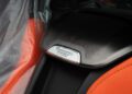 Close-up of a car speaker with a metallic “Burmester High-End Surround Sound-System” badge, surrounded by orange and black upholstery—seen inside the 2025 Chevrolet Corvette ZR1 with a thrilling 1064HP, now for sale.