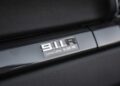 Close-up of a 2016 Porsche 911 R interior badge displaying "911 R Limited Edition No. 000/991" on a carbon fiber dashboard trim.
