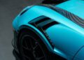 Close-up of the front left fender and wheel of an Ipanema Blue 911 GT3 RS, showing a carbon fiber vent and aerodynamic detailing at Porsche Exchange.