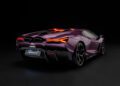 A 1:8 Revuelto model by Amalgam showcases a purple Lamborghini sports car from the rear three-quarter view, its illuminated taillights glowing against a black background.