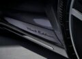 Close-up of a Porsche 2026 Taycan door sill with "Black Edition" written on it, next to part of a tire and wheel.