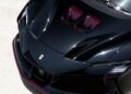 Overhead view of a sleek, black Ferrari Beverly Hills sports car with a Ferrari logo, showcasing aerodynamic lines and glossy finish.