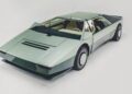 A futuristic, angular, silver-green concept car with a low profile, pop-up headlights, and a glass roof—one of the wedge-shaped wonders set to steal the spotlight at the Petersen Museum’s upcoming exhibit. Displayed on a white background.