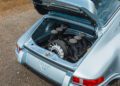 A silver Theon Design classic sports car with its rear engine compartment open, showing a clean, detailed air-cooled 911 engine.